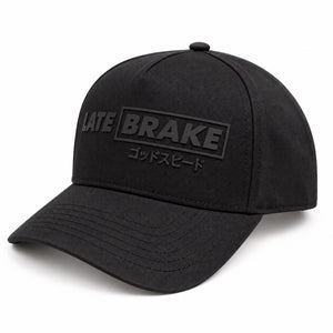 Late Brake black curved brim cap with a tonal LATE BRAKE wordmark on a white background.