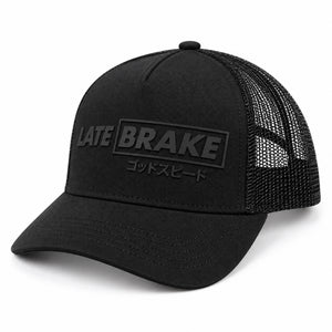 Late Brake black mesh trucker hat with a tonal LATE BRAKE wordmark on a white background.