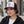 Woman wearing a Late Brake burgundy, white and black trucker hat with an embroidered LB monogram outdoors.