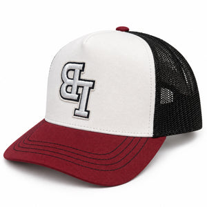 Late Brake burgundy, white and black trucker hat with an embroidered LB monogram on a white background.