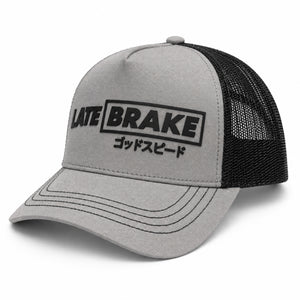 Late Brake grey and black mesh trucker hat with a black LATE BRAKE wordmark on a white background.