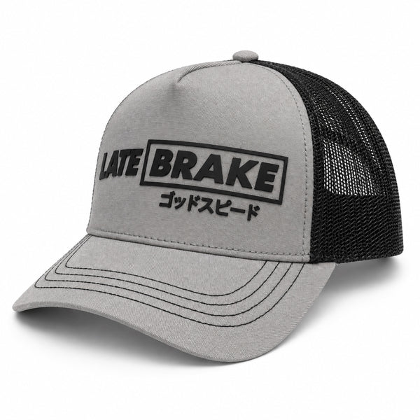 Late Brake grey and black mesh trucker hat with a black LATE BRAKE wordmark on a white background.