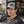 Man wearing a Late Brake grey and black mesh trucker hat with a black LATE BRAKE wordmark outdoors.