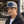 Man wearing a Late Brake light grey flat brim cap with a blue LATE BRAKE patch outdoors.