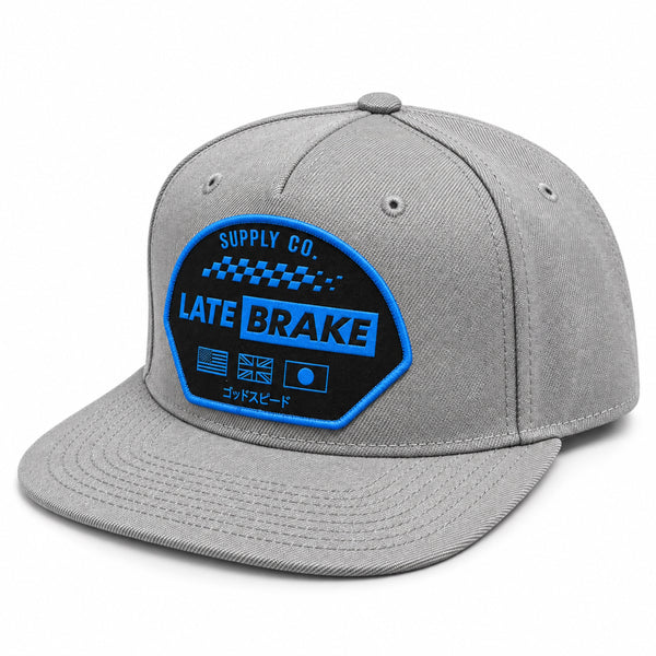 Late Brake light grey flat brim cap with a blue LATE BRAKE patch on a white background.